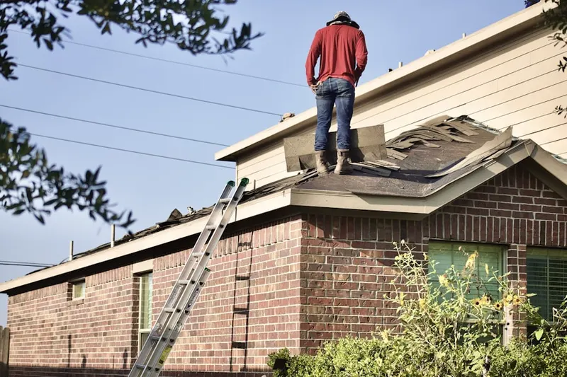 Professional roofer working on a residential roof in Uvalde